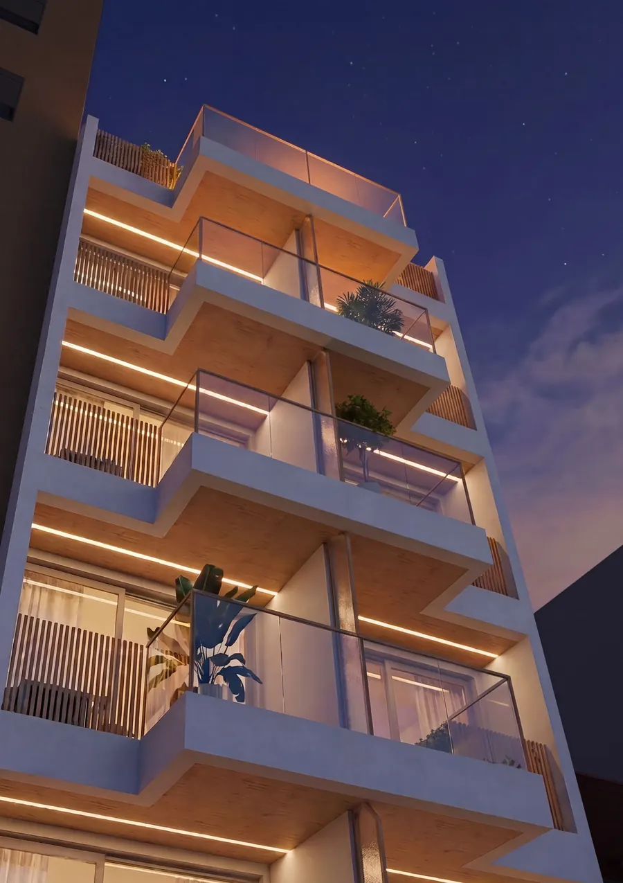 Fachada do L74 Studios ao entardecer, com varandas iluminadas e o céu de Laranjeiras